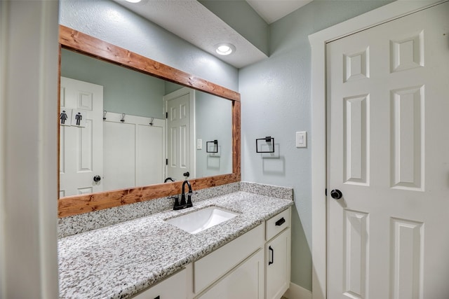 4650 Hickory Downs Dr, Houston, TX 77084 - bathroom with a textured wall and vanity