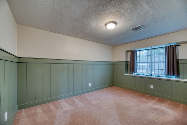 4650 Hickory Downs Dr, Houston, TX 77084 - carpeted empty room featuring wainscoting and a textured ceiling