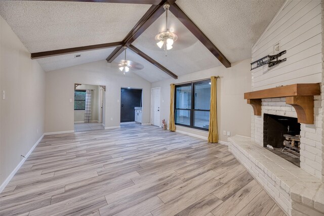 4650 Hickory Downs Dr, Houston, TX 77084 - unfurnished living room with a brick fireplace, ceiling fan, light wood-style flooring, a textured ceiling, and baseboards
