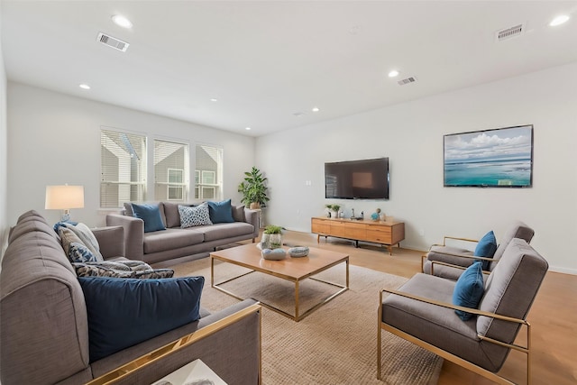 living room with recessed lighting and baseboards