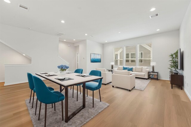 dining space with light wood-type flooring, recessed lighting, and baseboards