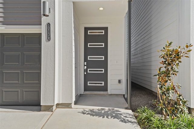 view of exterior entry featuring a garage