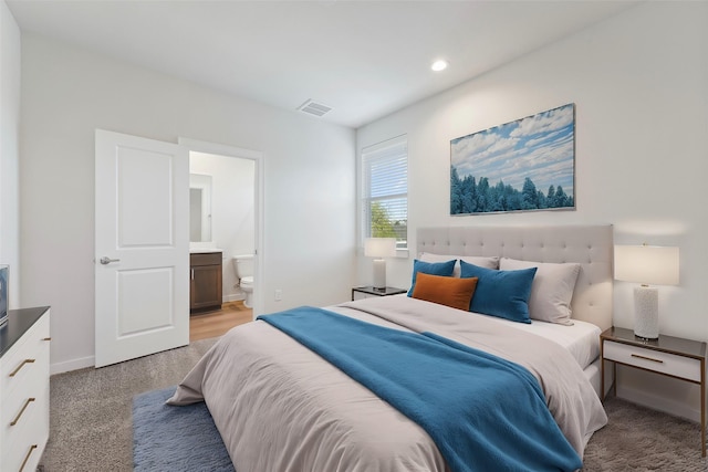 bedroom featuring light carpet, ensuite bath, recessed lighting, and baseboards