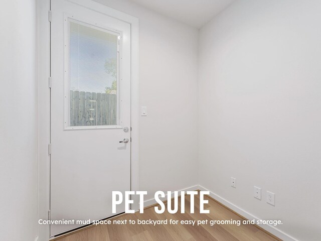 entryway with wood finished floors and baseboards