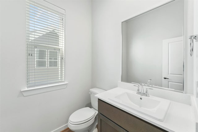 half bathroom featuring toilet and vanity