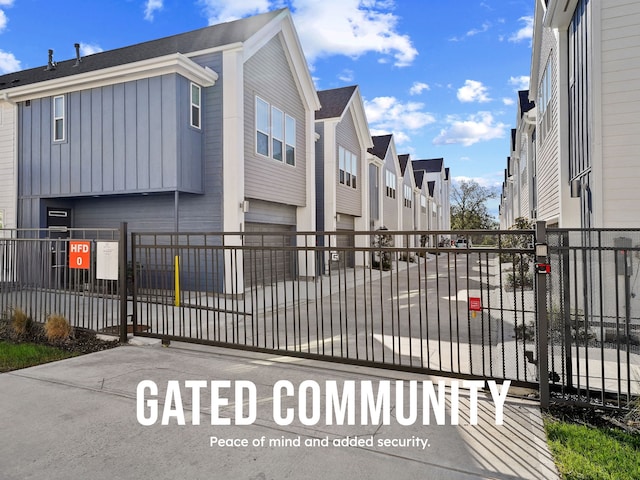 gate with a fenced front yard and a residential view
