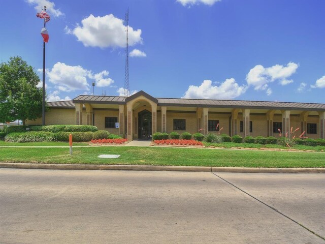 16218 Capri Dr, Jersey Village, TX 77040 - ranch-style home with a standing seam roof, a front yard, and metal roof