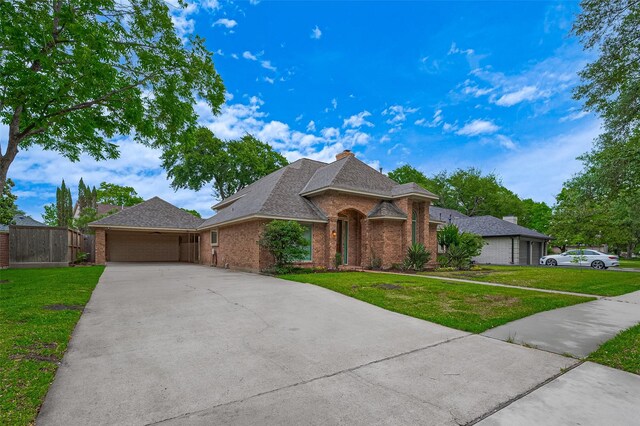 16218 Capri Dr, Jersey Village, TX 77040 - view of front of home with brick siding, driveway, and a garage