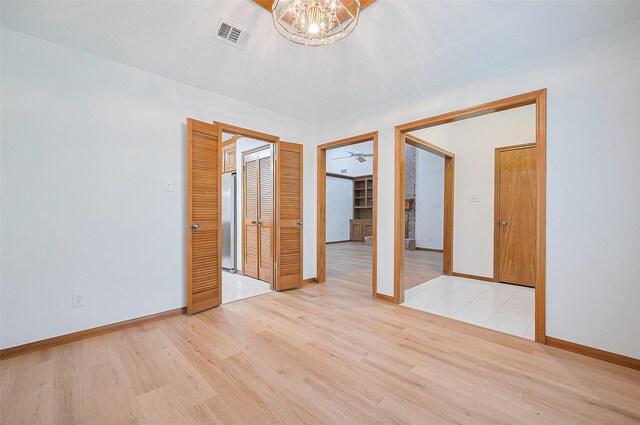 16218 Capri Dr, Jersey Village, TX 77040 - spare room with light wood-style flooring, a chandelier, and baseboards