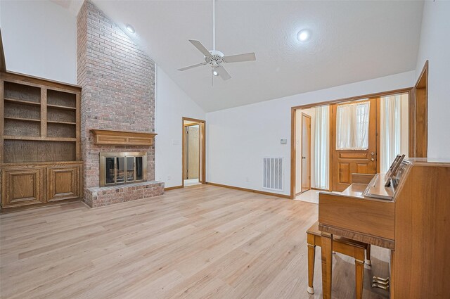 16218 Capri Dr, Jersey Village, TX 77040 - living room with high vaulted ceiling, ceiling fan, a fireplace, light wood-style floors, and baseboards
