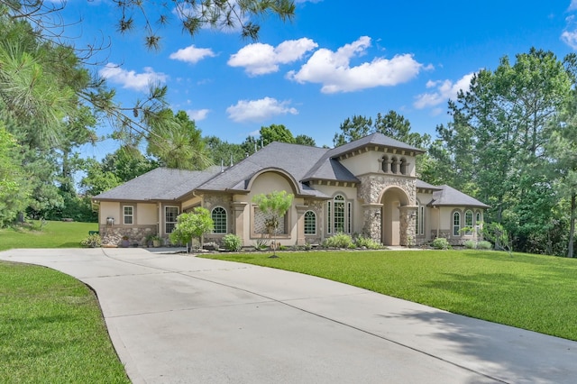 26118 Upper Beacon Pl, Montgomery, TX 77316 - view of front of house with stucco siding, stone siding, a front yard, and driveway