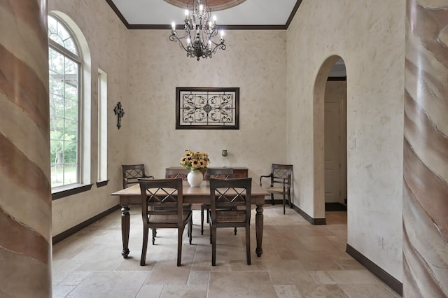 26118 Upper Beacon Pl, Montgomery, TX 77316 - dining area featuring arched walkways, stone tile floors, ornamental molding, baseboards, and a chandelier