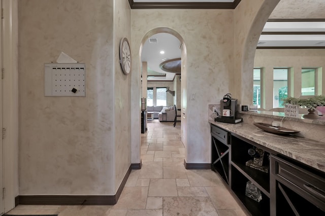 26118 Upper Beacon Pl, Montgomery, TX 77316 - bar area with stone tile flooring, arched walkways, and baseboards