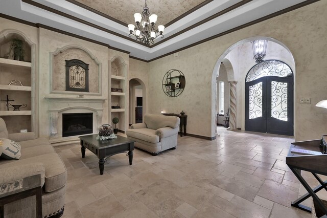 26118 Upper Beacon Pl, Montgomery, TX 77316 - living room with arched walkways, built in shelves, french doors, a chandelier, and stone tile floors
