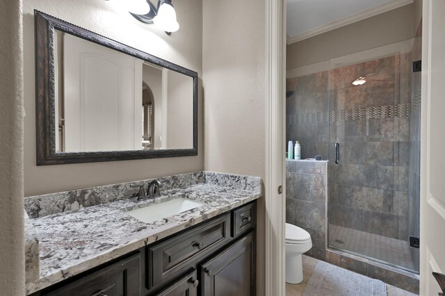 26118 Upper Beacon Pl, Montgomery, TX 77316 - bathroom featuring toilet, crown molding, vanity, a stall shower, and tile patterned floors