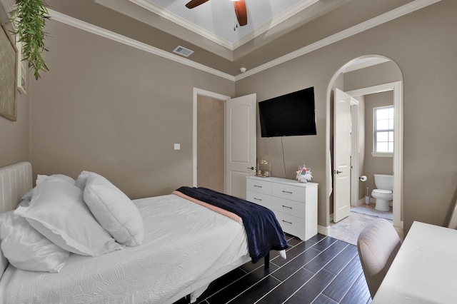 26118 Upper Beacon Pl, Montgomery, TX 77316 - bedroom featuring arched walkways, connected bathroom, wood tiled floors, crown molding, and ceiling fan