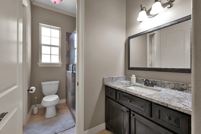 26118 Upper Beacon Pl, Montgomery, TX 77316 - bathroom featuring vanity, toilet, a stall shower, ornamental molding, and baseboards