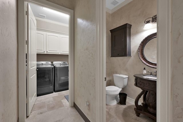 26118 Upper Beacon Pl, Montgomery, TX 77316 - bathroom with separate washer and dryer, crown molding, toilet, baseboards, and stone finish floors