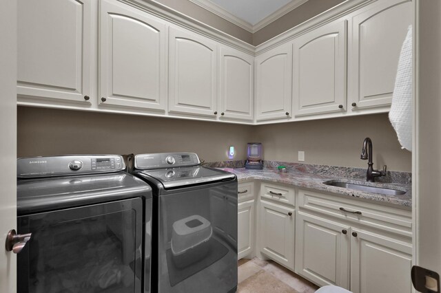 26118 Upper Beacon Pl, Montgomery, TX 77316 - laundry room featuring cabinet space, washing machine and clothes dryer, and ornamental molding
