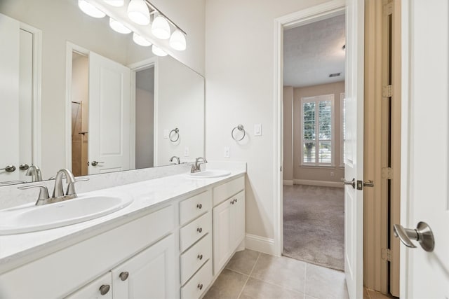 13906 Bell Valley Ct, Houston, TX 77059 - full bathroom with double vanity, baseboards, and tile patterned floors