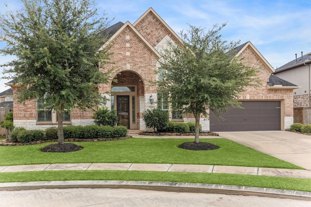 13906 Bell Valley Ct, Houston, TX 77059 - view of front of home featuring brick siding, concrete driveway, a front lawn, and stone siding