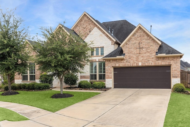 13906 Bell Valley Ct, Houston, TX 77059 - french country inspired facade with stone siding, an attached garage, concrete driveway, and a front lawn