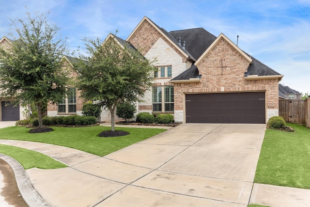 13906 Bell Valley Ct, Houston, TX 77059 - french country inspired facade with brick siding, concrete driveway, an attached garage, stone siding, and a shingled roof