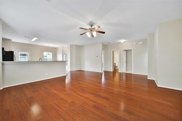 6010 Lovage Ave, Crosby, TX 77532 - unfurnished living room featuring a ceiling fan, wood finished floors, baseboards, and a sink