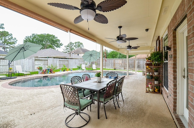 14411 Lawton Ridge Dr, Cypress, TX 77429 - fenced backyard featuring a patio, outdoor dining space, and ceiling fan