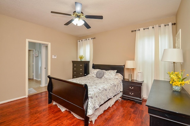 14411 Lawton Ridge Dr, Cypress, TX 77429 - bedroom with dark wood-style flooring, ceiling fan, and baseboards