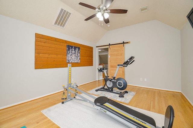 14411 Lawton Ridge Dr, Cypress, TX 77429 - exercise area featuring vaulted ceiling, ceiling fan, wood finished floors, a barn door, and baseboards