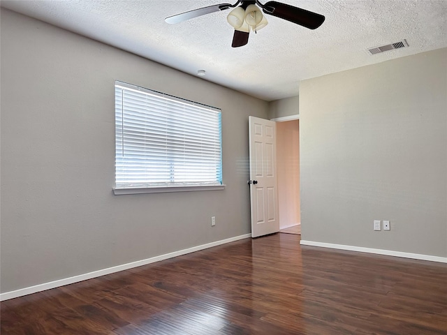 unfurnished room featuring wood finished floors, ceiling fan, a textured ceiling, and baseboards