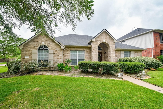 15203 Cypress Post Ln, Cypress, TX 77429 - view of front of home with brick siding, a front lawn, and a shingled roof