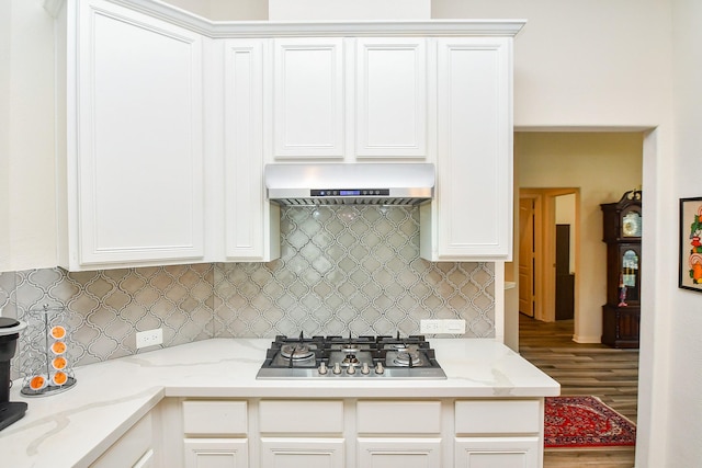 15203 Cypress Post Ln, Cypress, TX 77429 - kitchen with exhaust hood, stainless steel gas cooktop, wood finished floors, and white cabinetry