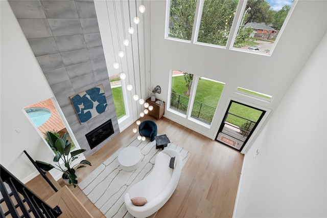 2202 Hewitt Dr, Houston, TX 77018 - living room featuring a towering ceiling, wood finished floors, and a tiled fireplace