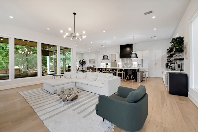 2202 Hewitt Dr, Houston, TX 77018 - living room with a chandelier, light wood finished floors, and recessed lighting