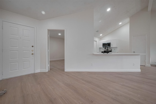 16250 Rancho Blanco Dr, Houston, TX 77083 - unfurnished living room featuring lofted ceiling, light wood finished floors, recessed lighting, and baseboards