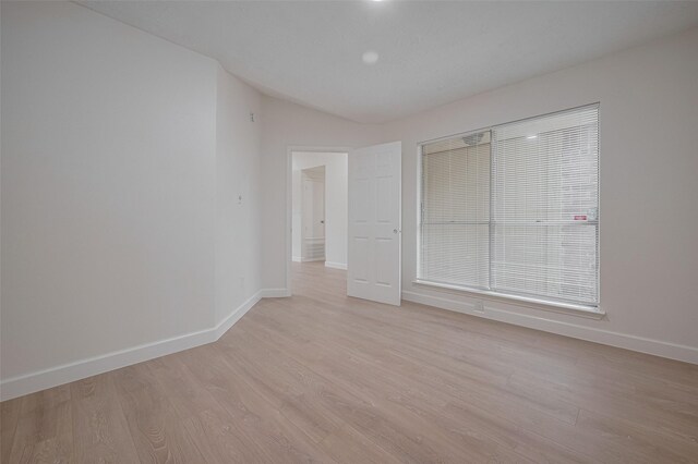 16250 Rancho Blanco Dr, Houston, TX 77083 - unfurnished bedroom with baseboards, light wood-style floors, and vaulted ceiling