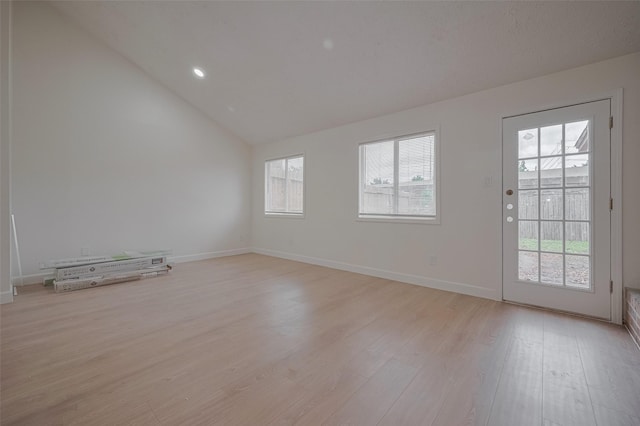 16250 Rancho Blanco Dr, Houston, TX 77083 - unfurnished room with vaulted ceiling, light wood finished floors, and baseboards