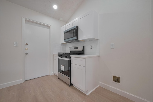 16250 Rancho Blanco Dr, Houston, TX 77083 - kitchen with appliances with stainless steel finishes, decorative backsplash, light wood-type flooring, lofted ceiling, and white cabinetry