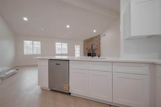 16250 Rancho Blanco Dr, Houston, TX 77083 - kitchen with stainless steel dishwasher, a sink, light wood-style flooring, white cabinets, and light countertops