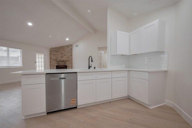 16250 Rancho Blanco Dr, Houston, TX 77083 - kitchen featuring stainless steel dishwasher, a sink, a peninsula, light wood finished floors, and white cabinets