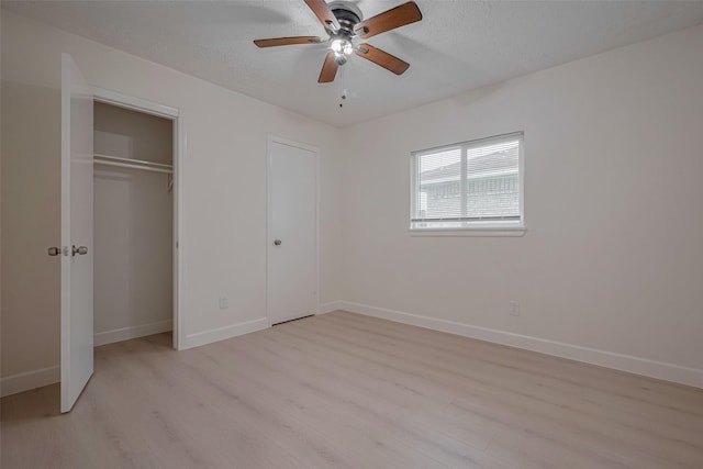 16250 Rancho Blanco Dr, Houston, TX 77083 - unfurnished bedroom featuring light wood-style flooring, baseboards, a textured ceiling, and ceiling fan