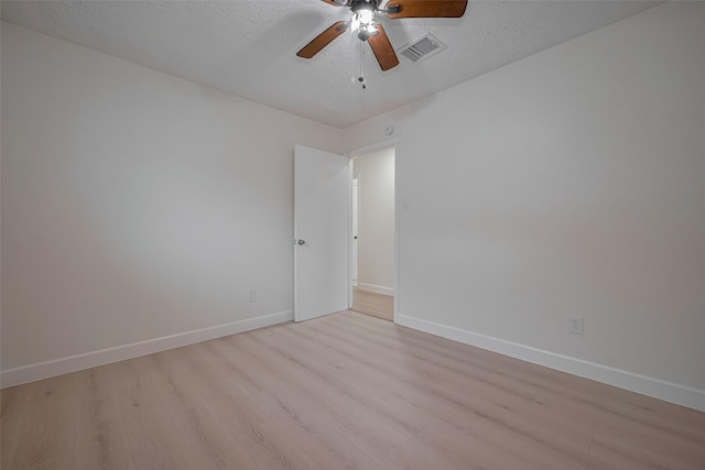 16250 Rancho Blanco Dr, Houston, TX 77083 - empty room with light wood finished floors, a ceiling fan, baseboards, and a textured ceiling