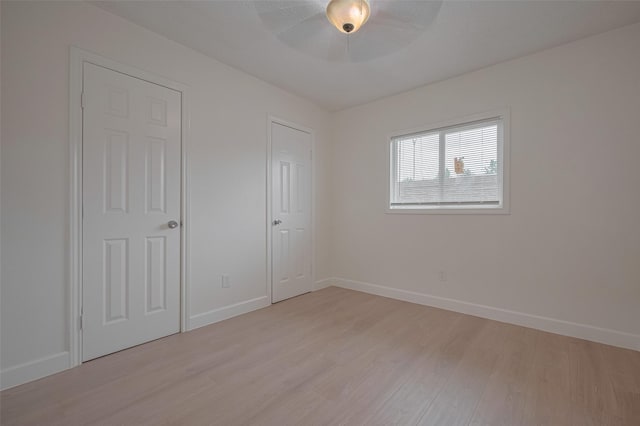 16250 Rancho Blanco Dr, Houston, TX 77083 - unfurnished bedroom with light wood-style flooring, baseboards, and ceiling fan