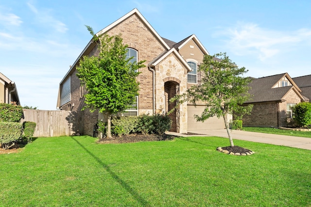french country inspired facade featuring brick siding, concrete driveway, and a garage