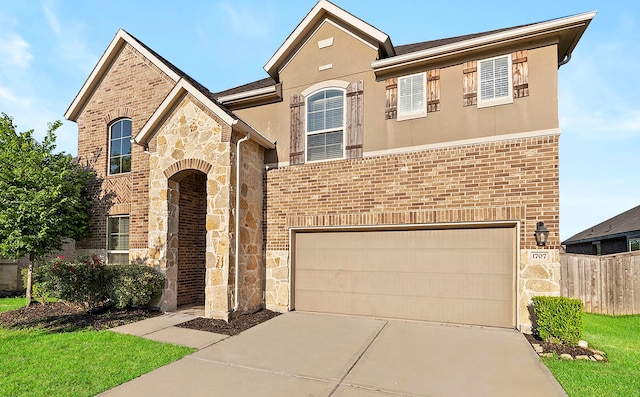 view of front of home featuring stone siding, an attached garage, concrete driveway, and fence