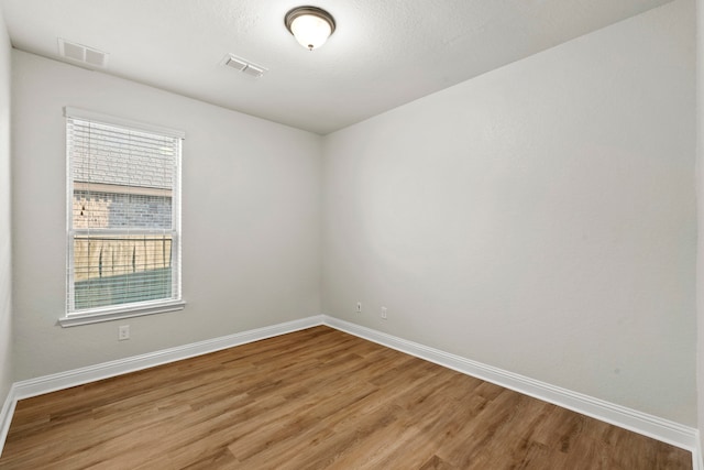 unfurnished room with light wood-style floors and baseboards