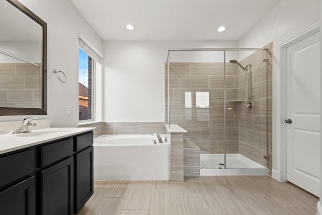 full bath with a shower stall, a garden tub, vanity, and tile patterned floors