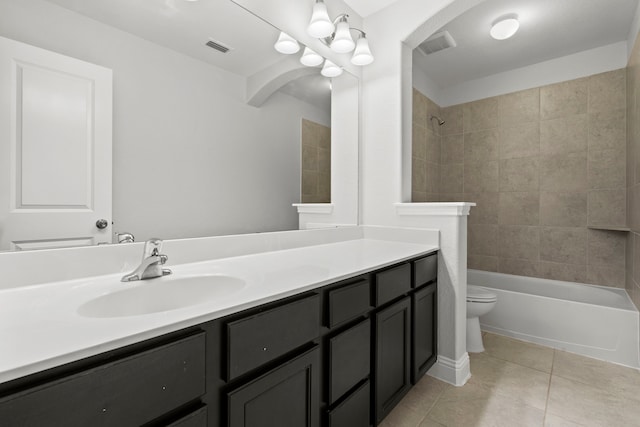 full bathroom featuring toilet, tile patterned floors, vanity, and shower / bathtub combination